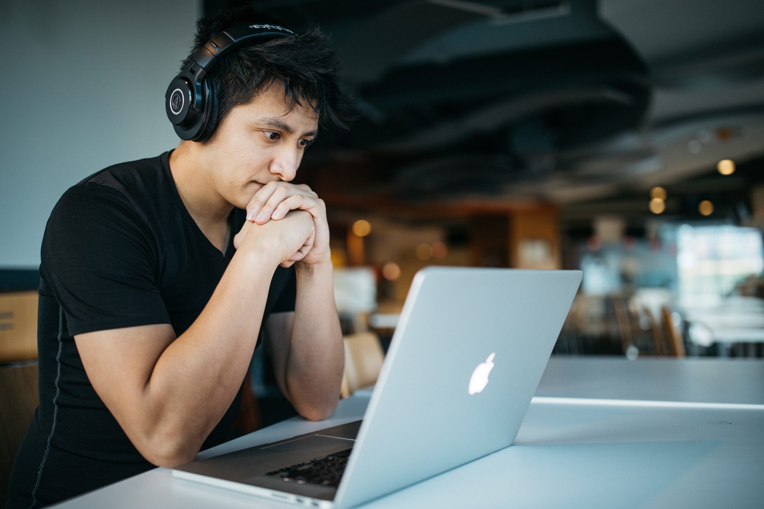 Man at desk wearing headphones staying focused at work.
