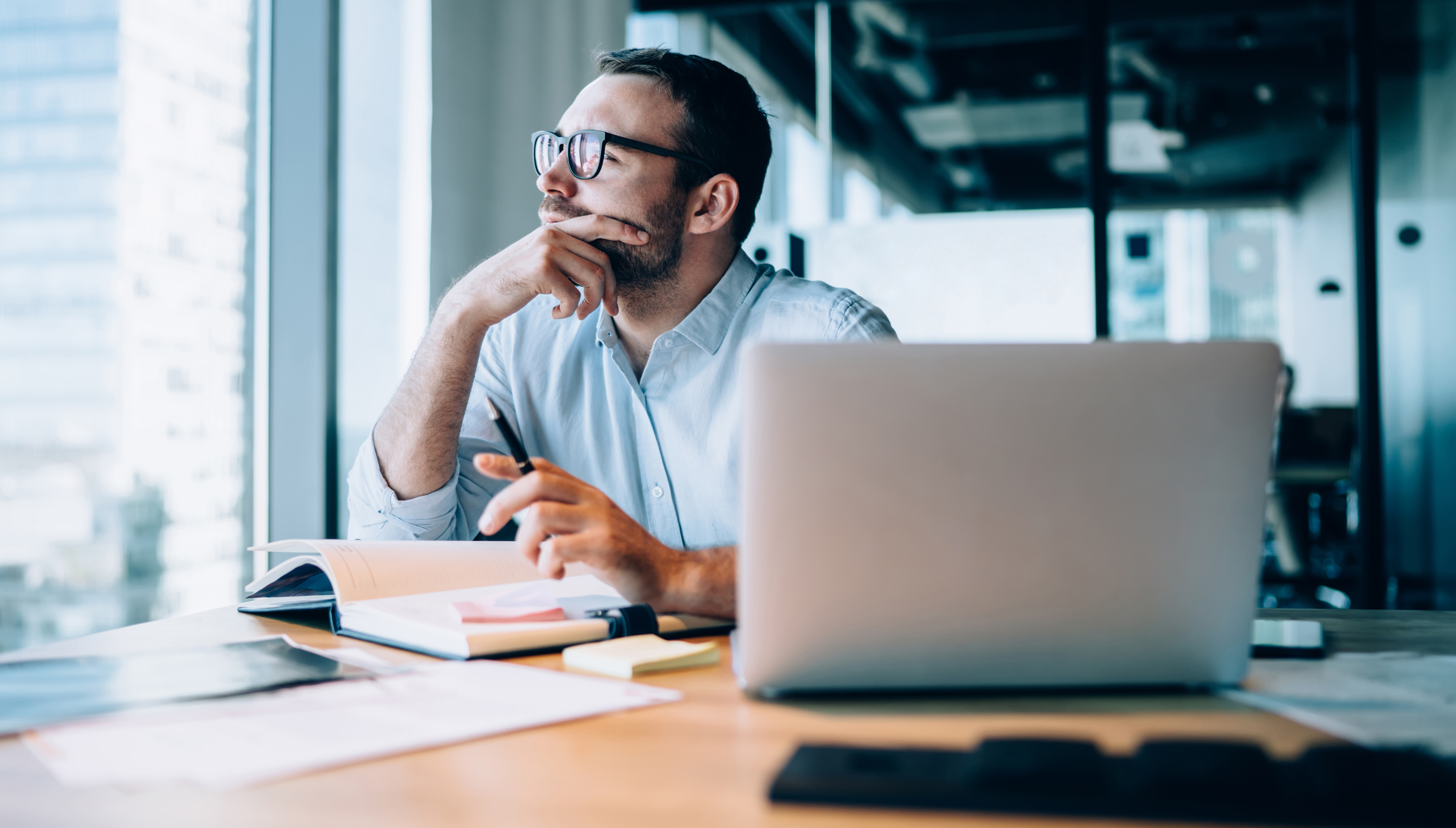 Quiet Preparation: Man at desk deep in thought.