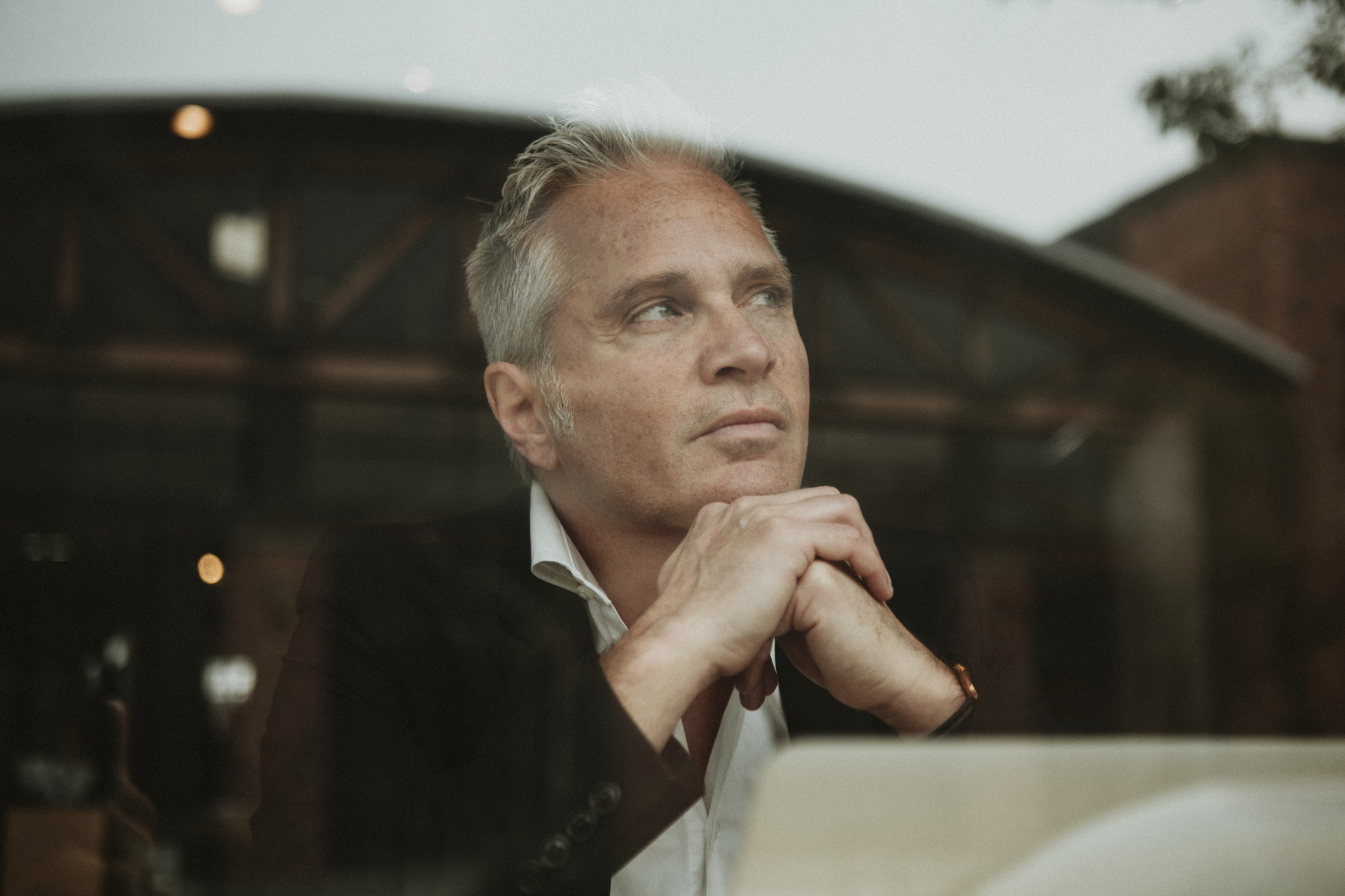 A man takes time to think in a quiet meeting.