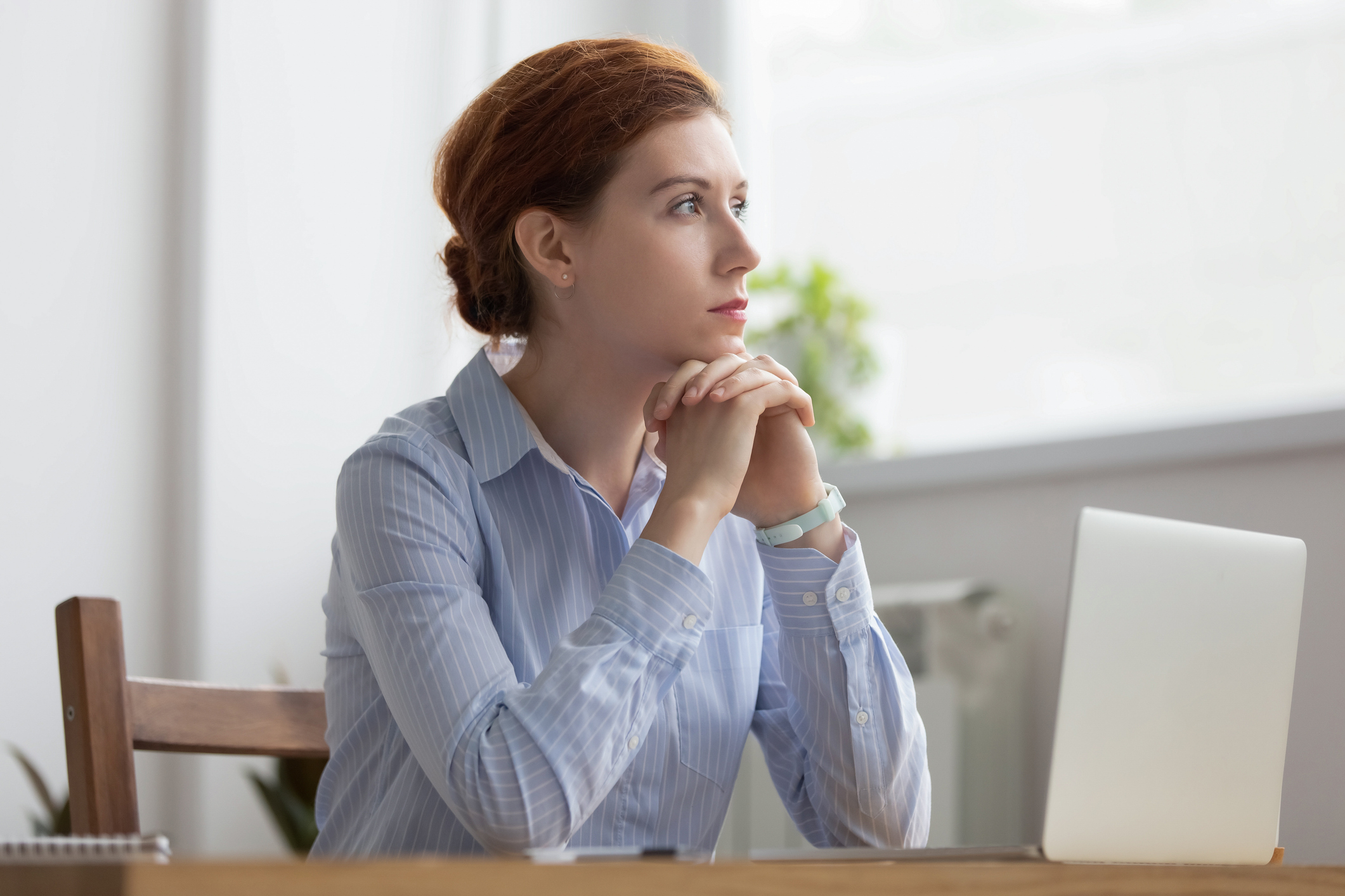 Think at work. Image of professional woman at desk thinking.