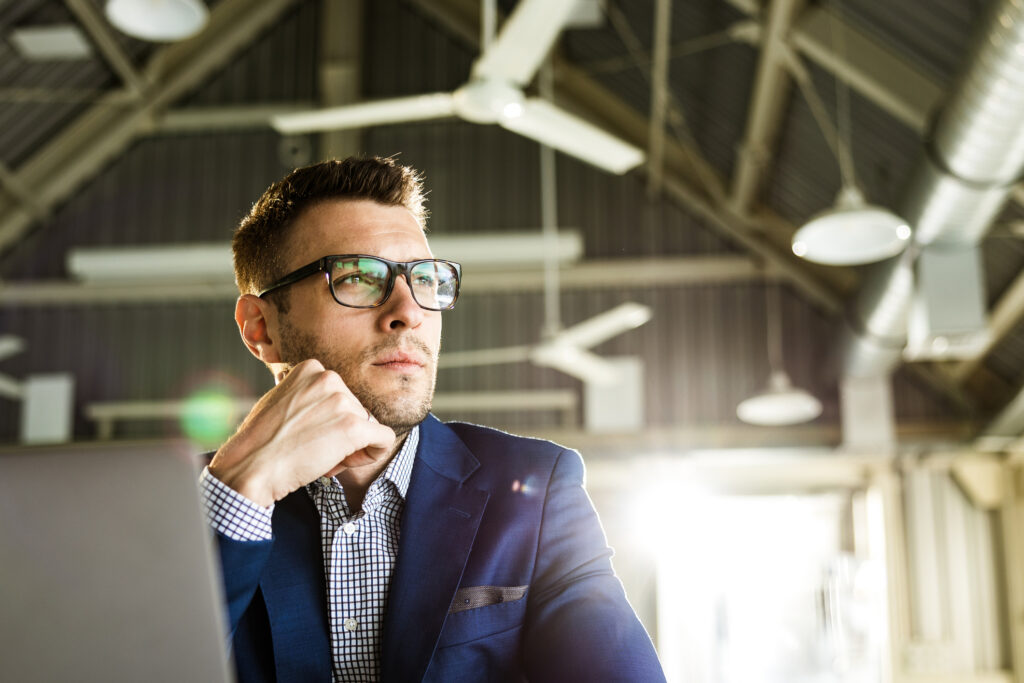 Photo of businessman at desk thinking